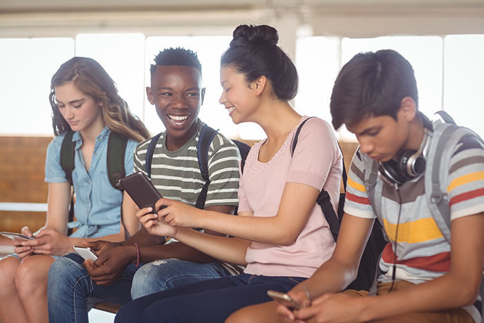 Image of teenagers using mobile phone