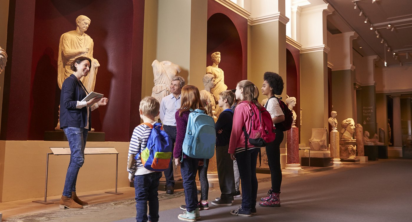 Students wth guide and teacher at museum