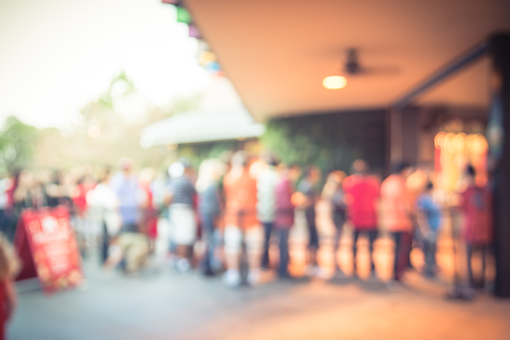 People queuing outside a visitor attraction 